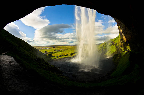 istock Cave behind Seljalandsfoss waterfall,river Seljalandsa,Iceland 498257790
