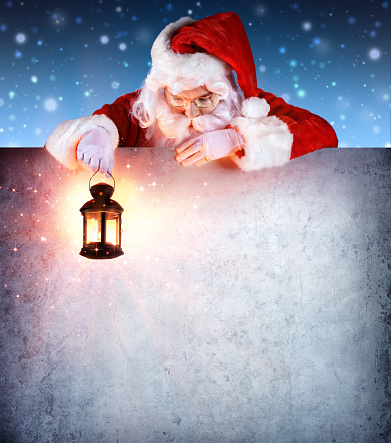 Santa Clause holding Lantern, looking down a empty signboard