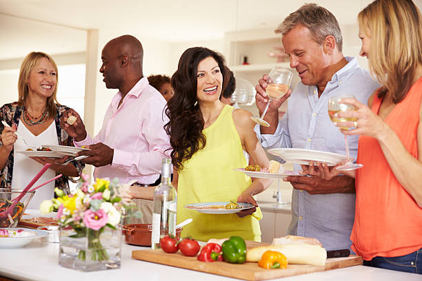 istock Group Of Mature Friends Enjoying Buffet At Dinner Party 498275904