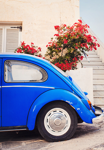 Naousa, Greece - October 16, 2015: Blue old Volkswagen Beetle parked on a picturesque street of Naousa, Paros island,Greece.