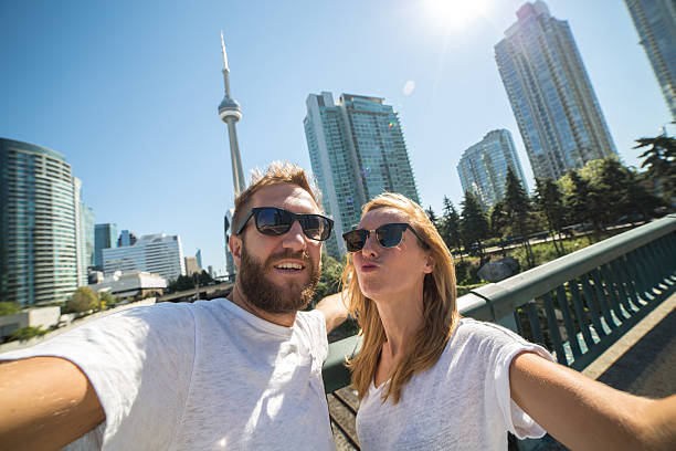 istock Young adults taking selfie portrait in Toronto using mobile phone 498278524