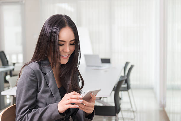 istock business woman using smartphone 498278958