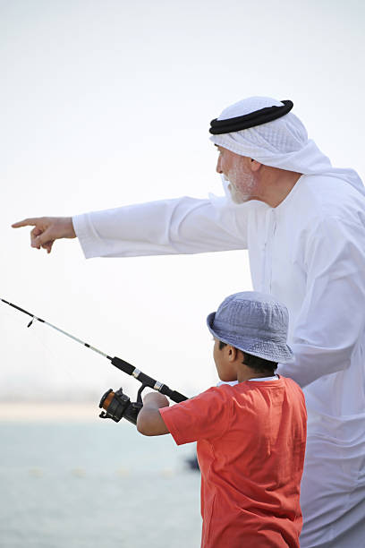 istock Two generations fishing together 498279102