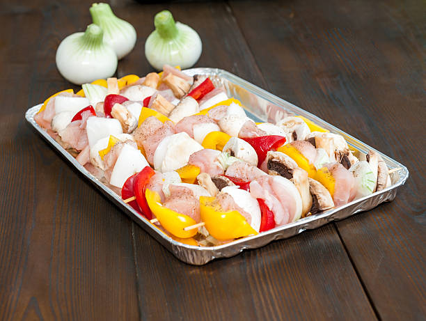 istock preparation for the barbecue - raw skewers on a tray 498279429