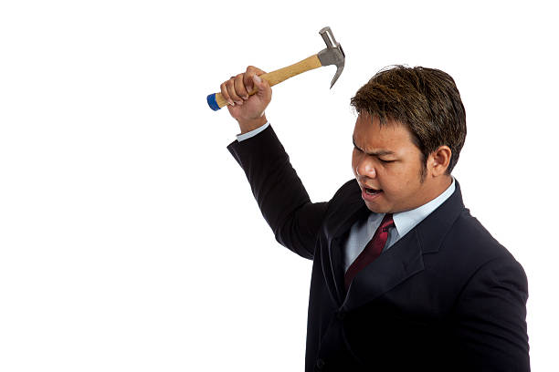 istock Aggressive Asian businessman about to hit with a hammer 498279547