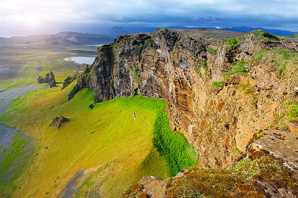 Snow capped peaks rise out of the clouds in Iceland's mountainous southern region