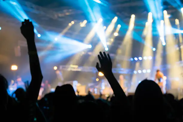 Photo of Bokeh lighting in outdoor concert with cheering audience