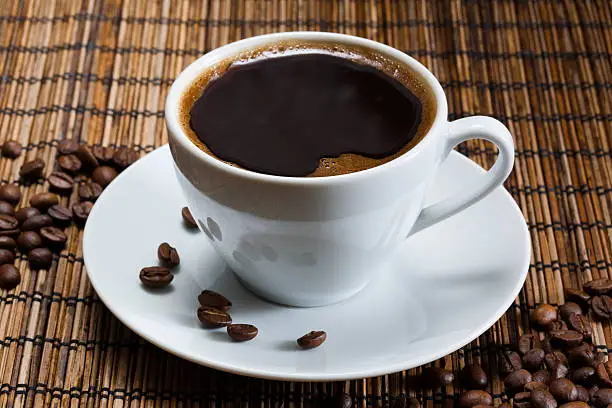 Photo of natural black coffee in a white cup