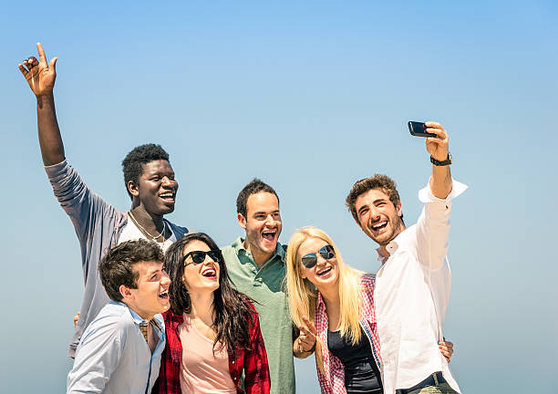 istock Group of multiracial friends taking a selfie at beach 498282929