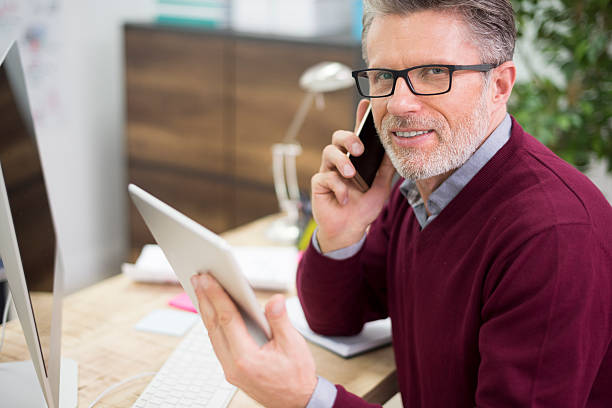 istock Busy man in the surrounding of technology 498283256