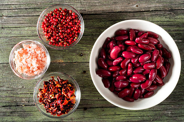 red beans and spices on wooden table stock photo
