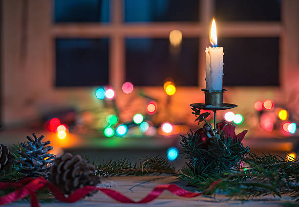 istock Candle with Christmas decoration, blurred light background 498283844