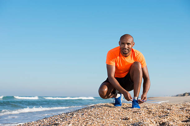 istock Athlete man tying his shoe. 498283888