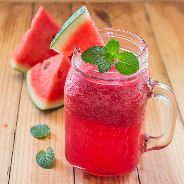 istock Fresh watermelon Smoothie in Mason jar on the wood background 498285104