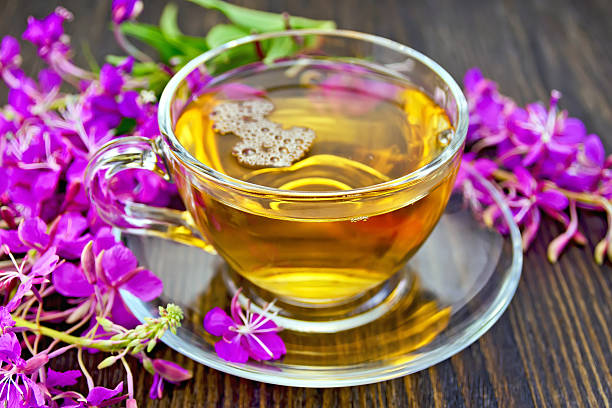 istock Tea from fireweed in glass cup on dark board 498297976