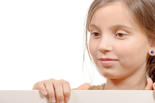 a beautiful young girl with a blank poster isolated  on white background