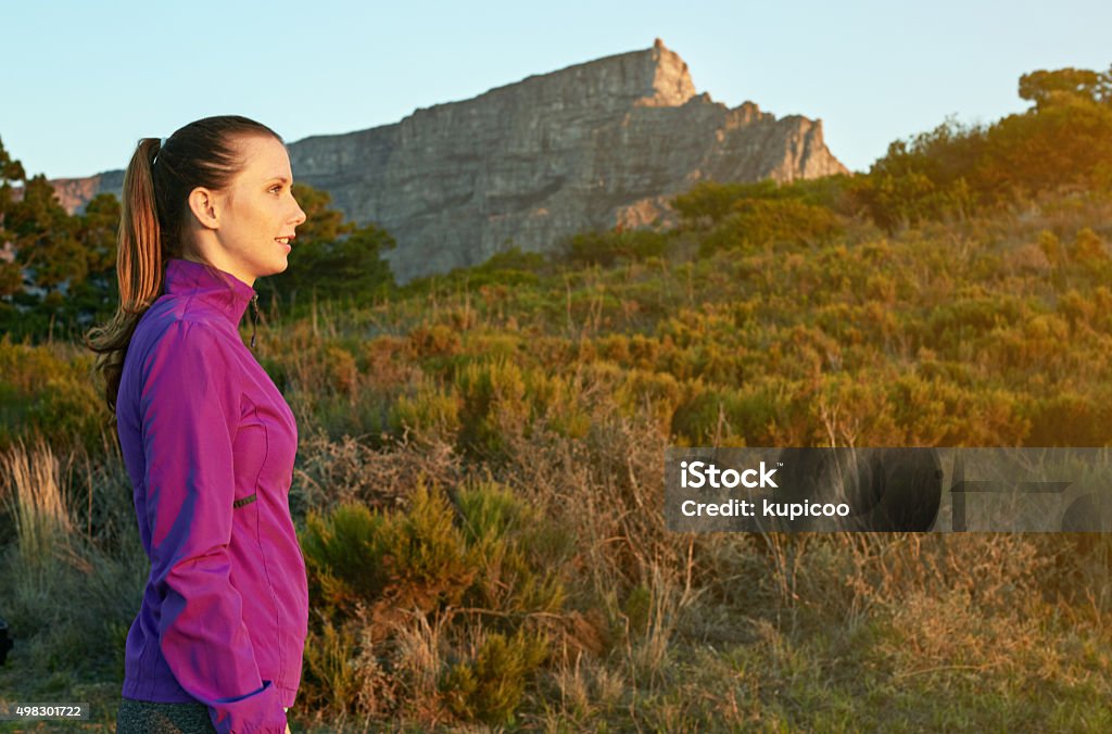 What a day to be outdoors! Shot of a young woman admiring the scenery while out for a nature walk 20-29 Years Stock Photo