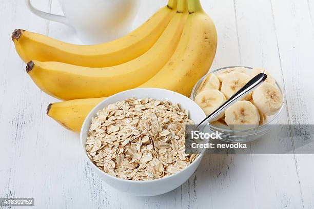 Bowl Of Oat Flakes With Sliced Banana Stock Photo - Download Image Now - 2015, Banana, Bowl