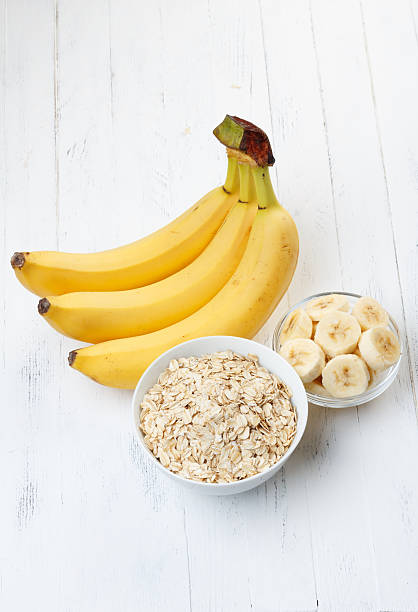 Bowl of oat flakes with sliced banana stock photo