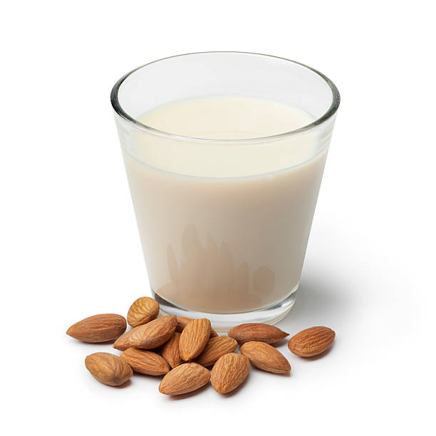 Almond milk with a heap of almonds