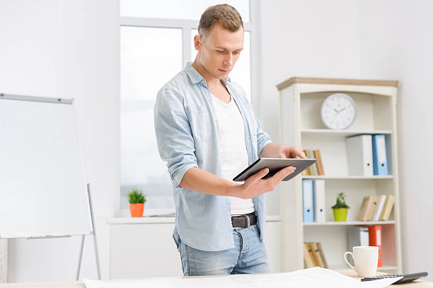 istock Male employee is working on the tablet 498302840