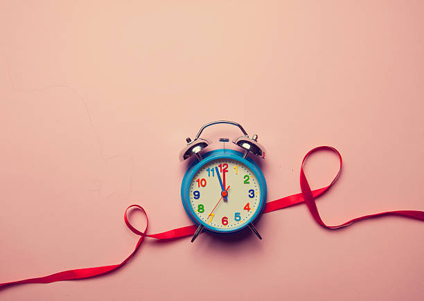 istock Alarm clock and red romantic ribbon 498303436