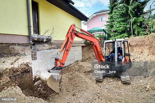 Family House Is Being Rebuilt With The Help Of Excavator Stock Photo - Download Image Now