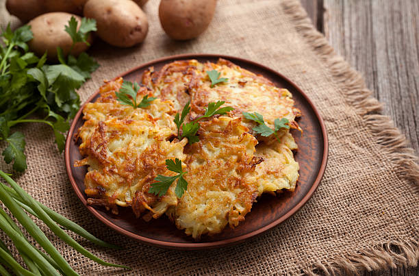 Potato pancakes or latke traditional homemade fried vegetable food recipe stock photo