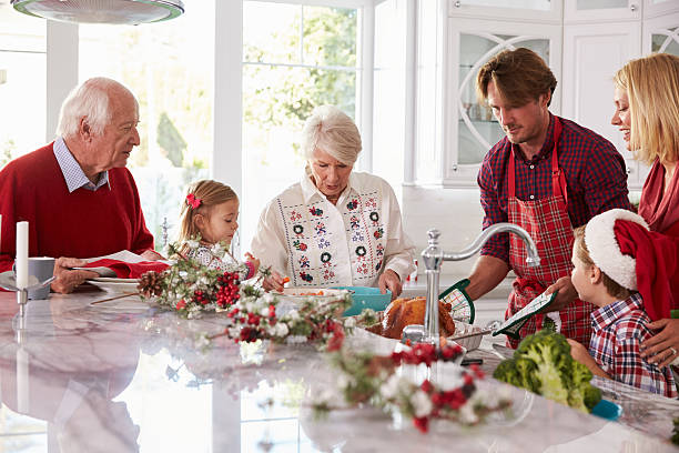 istock Extended Family Group Preparing Christmas Meal In Kitchen 498304258