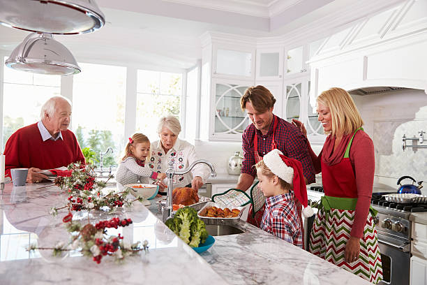 istock Extended Family Group Preparing Christmas Meal In Kitchen 498304370