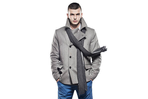 Handsome man in clothes for autumn-winter on a white background