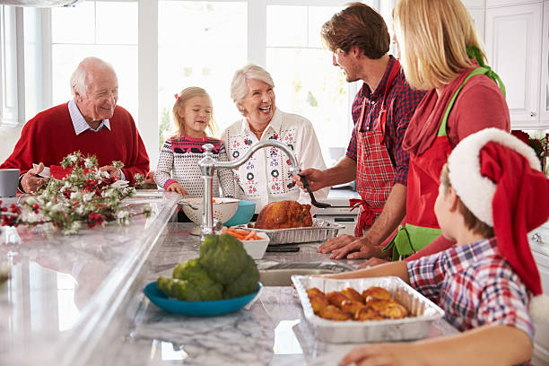 istock Extended Family Group Preparing Christmas Meal In Kitchen 498304634