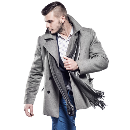 Handsome man in clothes for autumn-winter on a white background