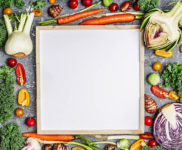 istock Health food background with vegetables around blank white chalkboard 498305964