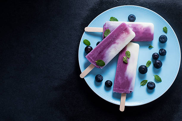 Yogurt and blueberry popsicle on plate
