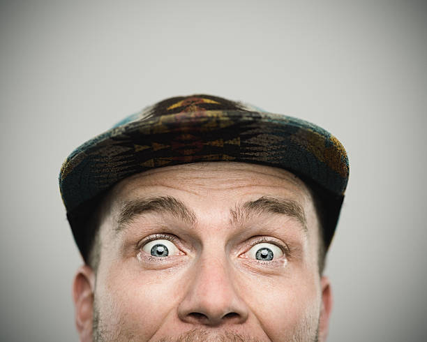 Nerdy young man making four different facial expression, studio shot.
