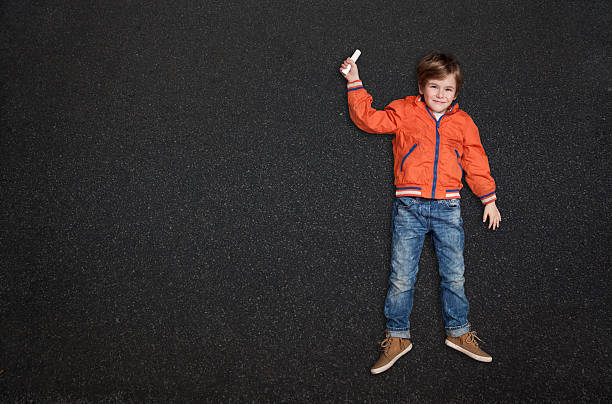 istock Cute Boy, with Chalk on Street/Tarmac 498308552