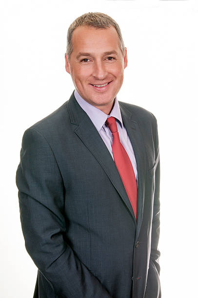 istock Cheerful mature businessman standing on white background 498308580