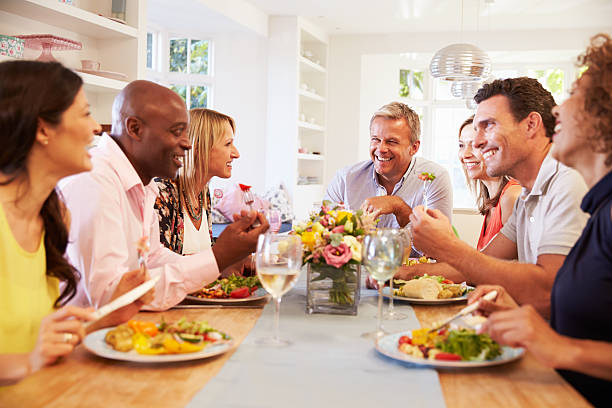 istock Mature Friends Sitting Around Table At Dinner Party 498308648