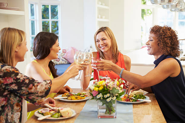 istock Mature Female Friends Sitting Around Table At Dinner Party 498309512