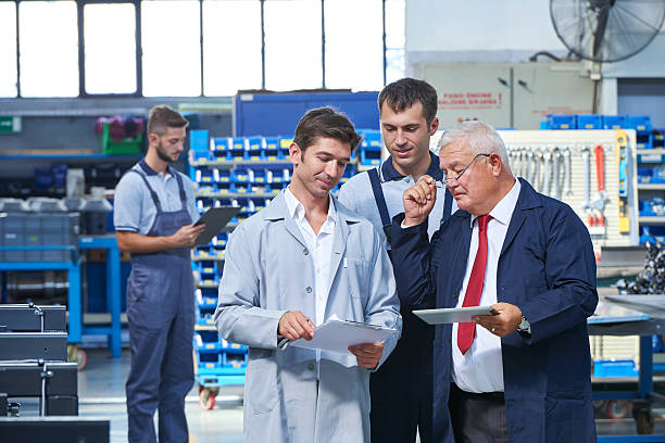 istock Supervisor and workers in factory 498310684