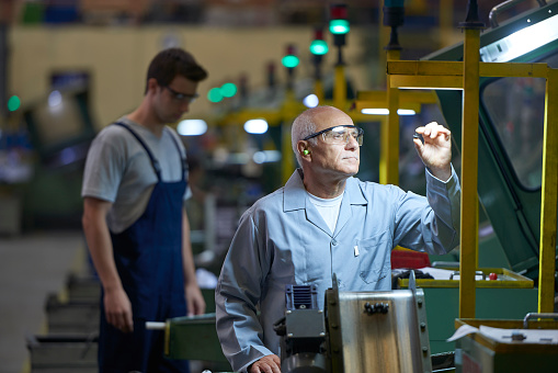 Worker checking product in bolt factory