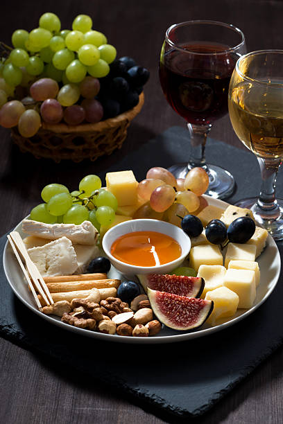 istock Plate with deli snacks and glasses of wine, vertical 498311606