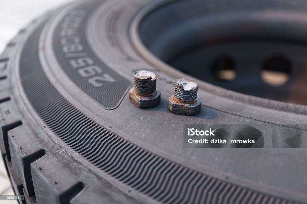 Broken wheel screws lying on bus tire 2015 Stock Photo