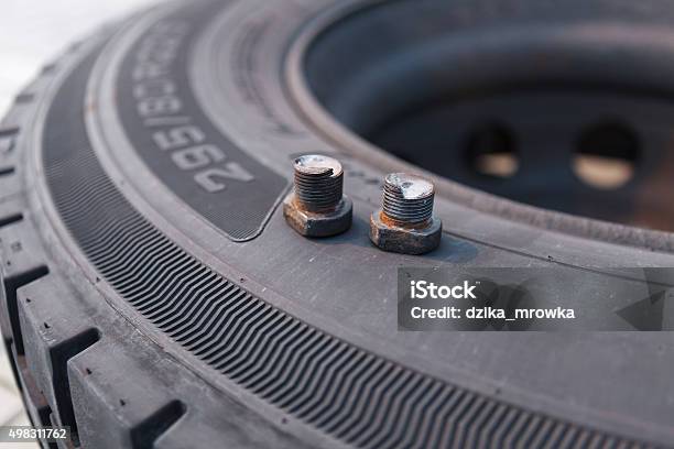 Broken Wheel Screws Lying On Bus Tire Stock Photo - Download Image Now - 2015, Accidents and Disasters, Broken