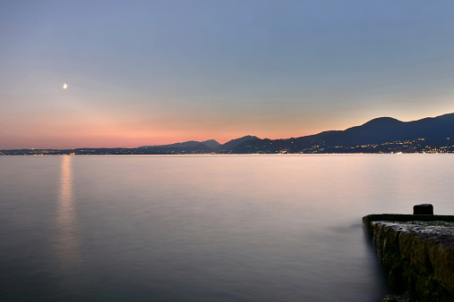 The silver sunset over Lake Garda resumed by Torri del Benaco.