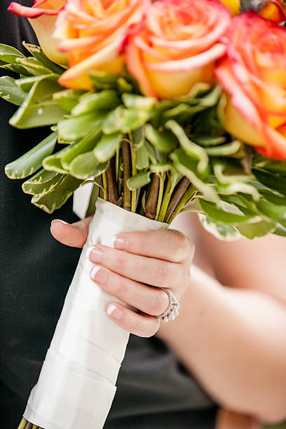 Wedding flowers in bride's hand stock photo