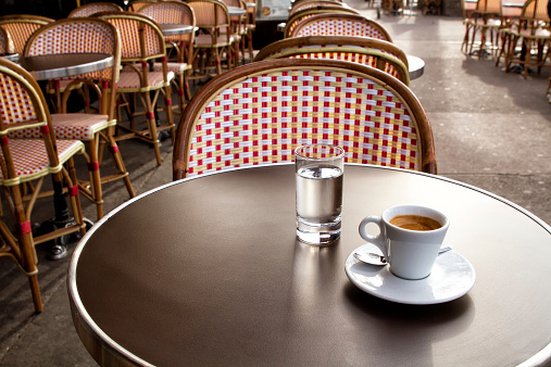 Coffee and water on a table of parisian's bar