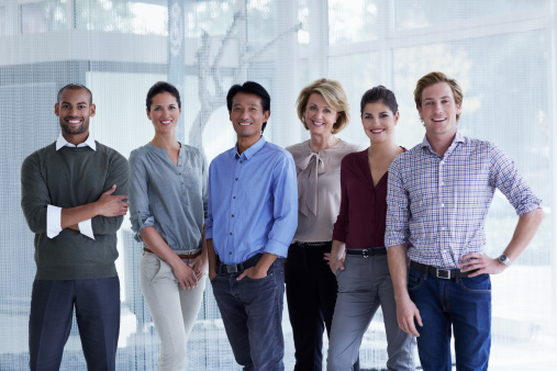 Portrait of confident businesspeople standing together in office