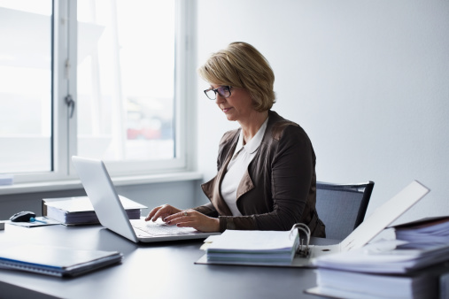 Businesswoman using laptop in office photo